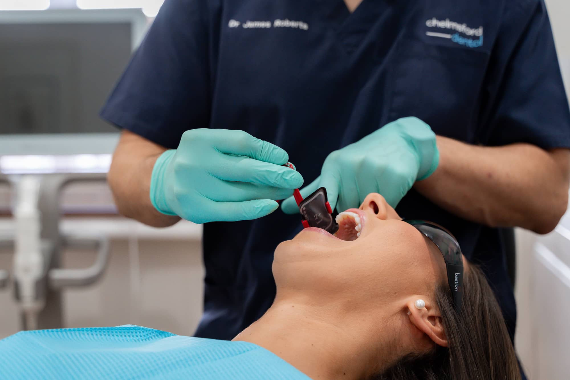 Dr. James from Chelmsford Dental preparing a dental bridge procedure with a patient