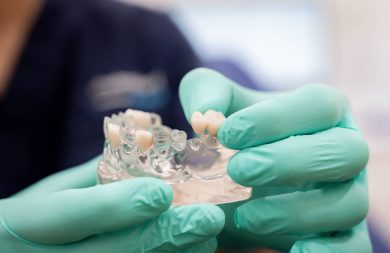 dentist demonstrating how a dental bridge works