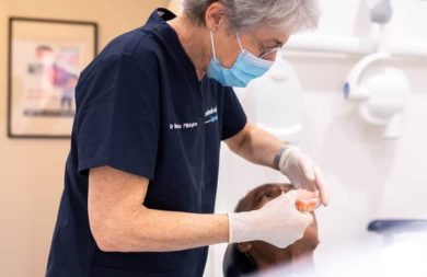 dentist-checking-patient-dentures