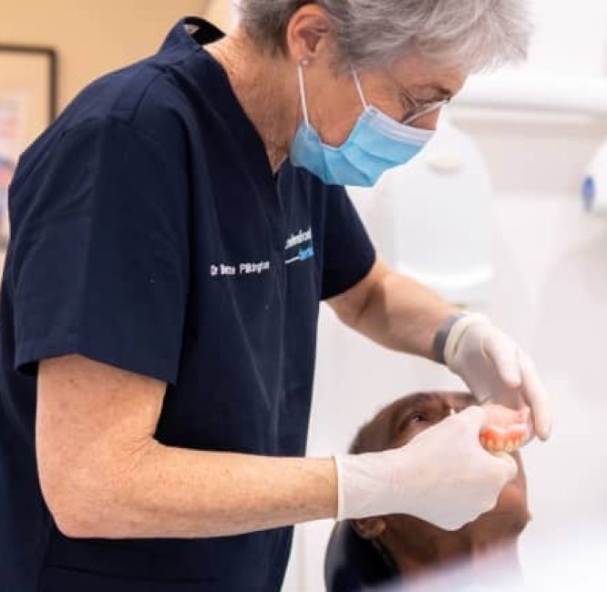 dentist-checking-patient-dentures