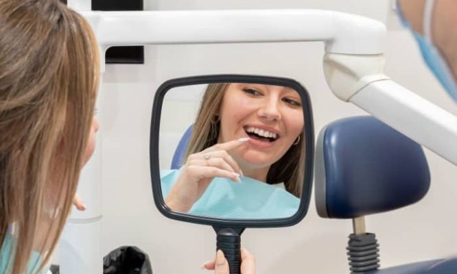 lady checking out her cosmetic dental work.