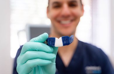 Dr. James holding custom mouth guard