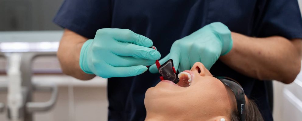 Dr. James from Chelmsford Dental preparing a dental bridge procedure with a patient