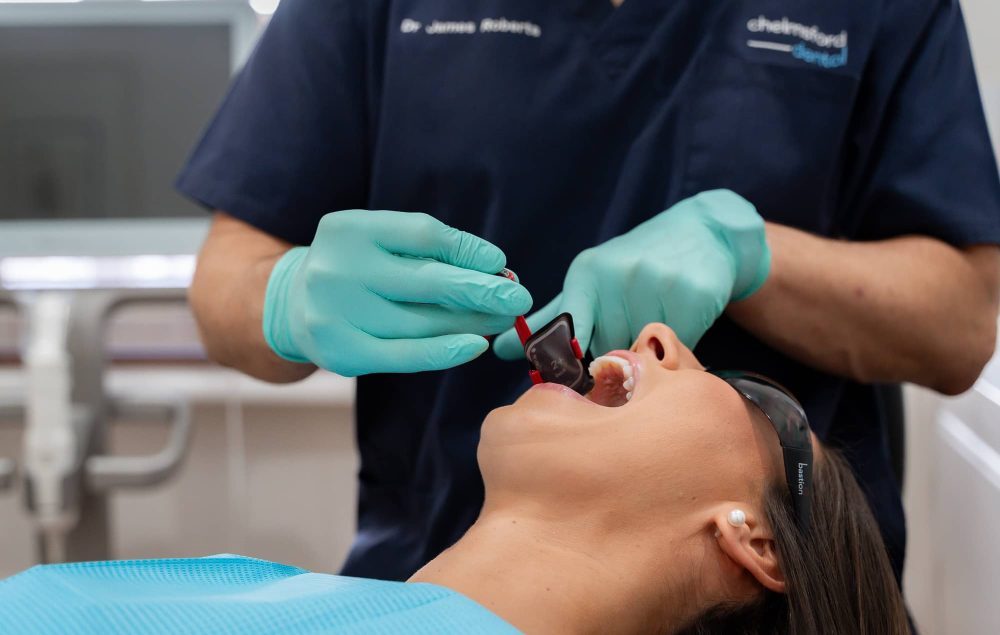 Dr. James from Chelmsford Dental preparing a dental bridge procedure with a patient